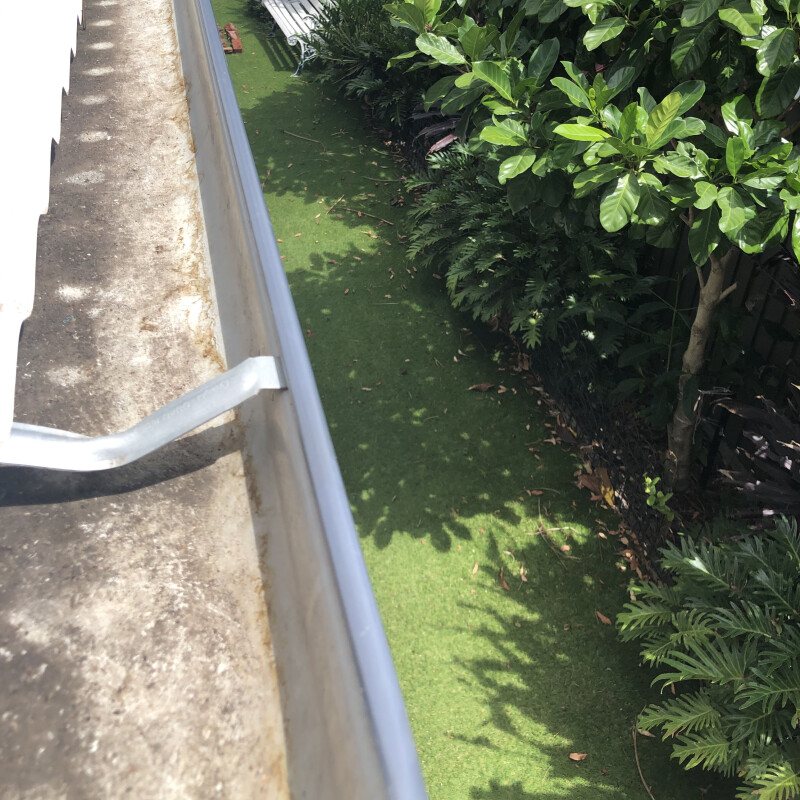A clean gutter with green grass below